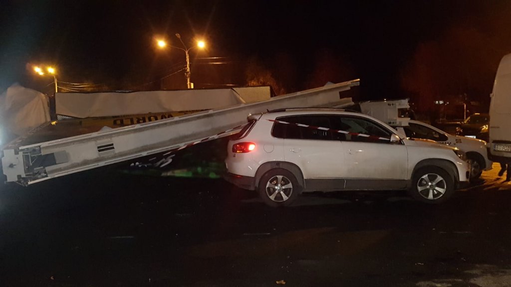 Dezastru într-o parcare din Cluj! 5 mașini, strivite de un panou publicitar smuls de vânt